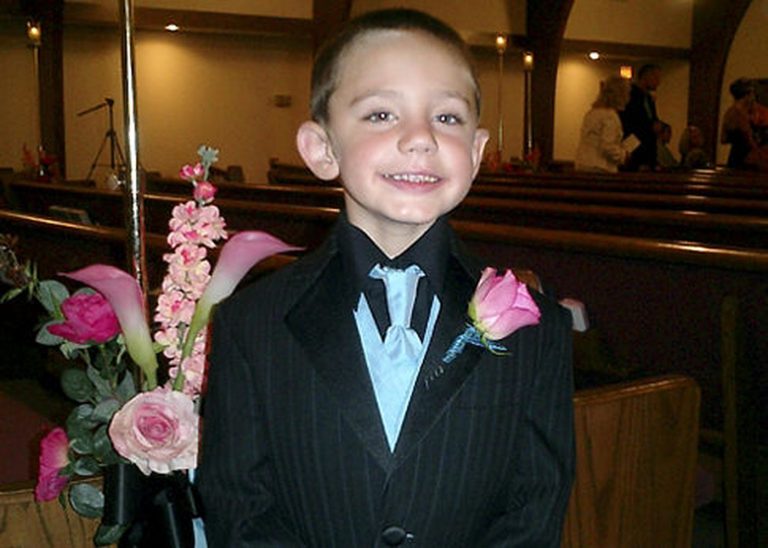 A child in a suit Description automatically generated with low confidence